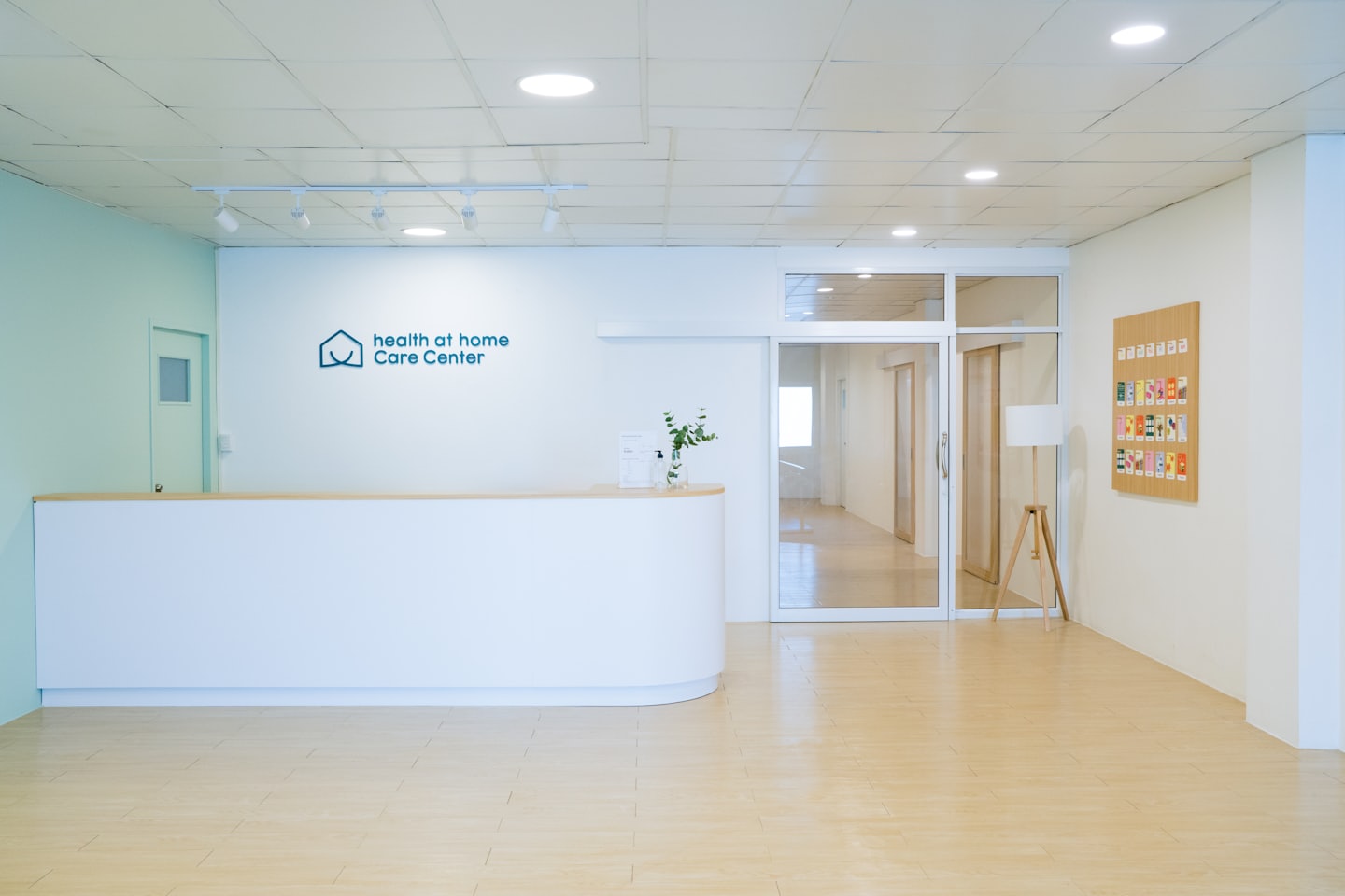 Modern reception desk in a clean healthcare facility hallway.