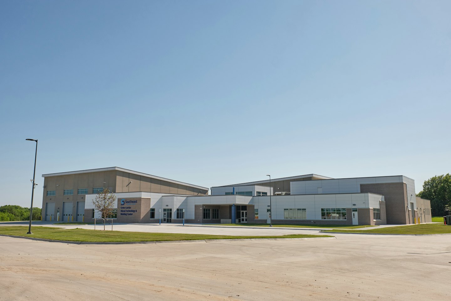 Modern vocational training center building surrounded by green lawns.